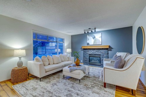 268 Mt Brewster Circle Se, Calgary, AB - Indoor Photo Showing Living Room With Fireplace
