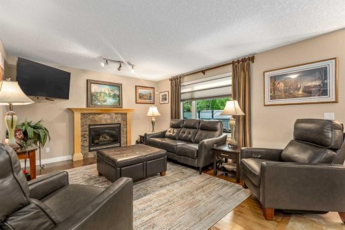 1733 Evergreen Drive Sw, Calgary, AB - Indoor Photo Showing Living Room With Fireplace
