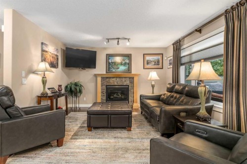 1733 Evergreen Drive Sw, Calgary, AB - Indoor Photo Showing Living Room With Fireplace