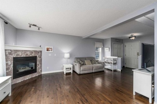 381 Hidden Valley Manor Nw, Calgary, AB - Indoor Photo Showing Living Room With Fireplace