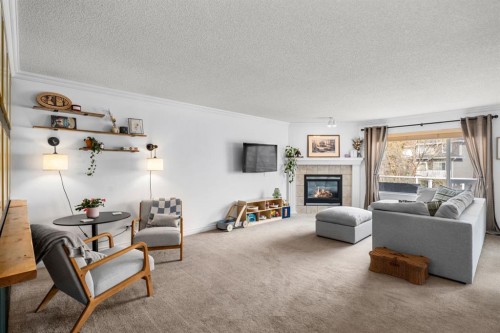 26 Somerset Crescent Sw, Calgary, AB - Indoor Photo Showing Living Room With Fireplace