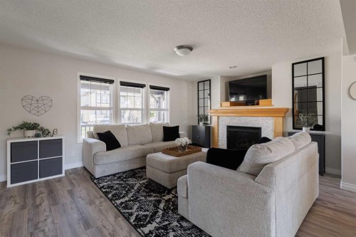 724 Prestwick Circle Se, Calgary, AB - Indoor Photo Showing Living Room With Fireplace