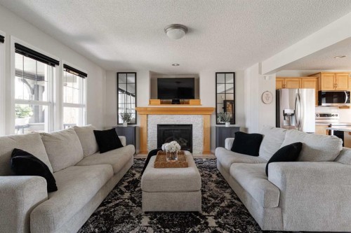 724 Prestwick Circle Se, Calgary, AB - Indoor Photo Showing Living Room With Fireplace
