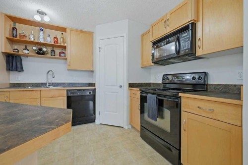 106-31 Everridge Square Sw, Calgary, AB - Indoor Photo Showing Kitchen With Double Sink