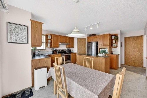 112 Hidden Ranch Crescent Nw, Calgary, AB - Indoor Photo Showing Kitchen With Double Sink