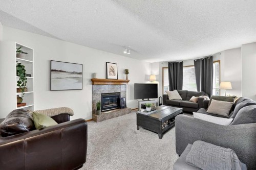 112 Hidden Ranch Crescent Nw, Calgary, AB - Indoor Photo Showing Living Room With Fireplace