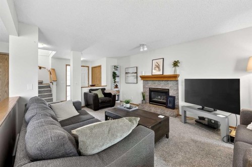 112 Hidden Ranch Crescent Nw, Calgary, AB - Indoor Photo Showing Living Room With Fireplace