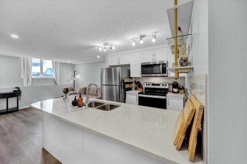 216-474 Seton Circle Se, Calgary, AB - Indoor Photo Showing Kitchen With Double Sink With Upgraded Kitchen