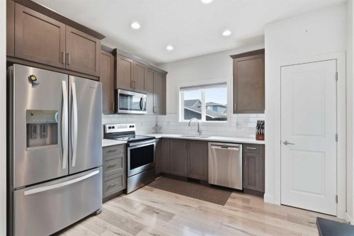 328 Bayview Street Sw, Airdrie, AB - Indoor Photo Showing Kitchen With Stainless Steel Kitchen
