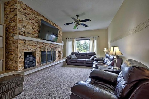 48 Deermont Way Se, Calgary, AB - Indoor Photo Showing Living Room With Fireplace