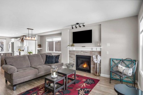 704 Stonehaven Drive, Carstairs, AB - Indoor Photo Showing Living Room With Fireplace