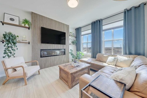164 Setonstone Manor Se, Calgary, AB - Indoor Photo Showing Living Room With Fireplace