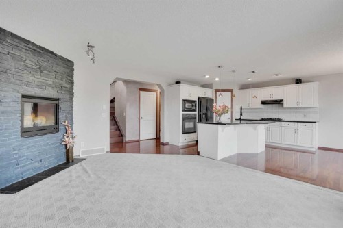 161 Panamount Close Nw, Calgary, AB - Indoor Photo Showing Kitchen With Fireplace
