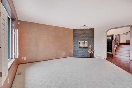 161 Panamount Close Nw, Calgary, AB - Indoor Photo Showing Other Room With Fireplace