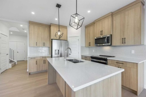 122 Sandpiper Bend, Chestermere, AB - Indoor Photo Showing Kitchen With Double Sink With Upgraded Kitchen