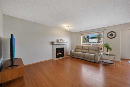 408 Bridlewood Court Sw, Calgary, AB - Indoor Photo Showing Living Room With Fireplace