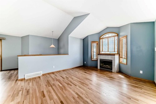 17 Ross Place, Crossfield, AB - Indoor Photo Showing Living Room With Fireplace