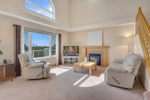 9 Panorama Hills Manor Nw, Calgary, AB - Indoor Photo Showing Living Room With Fireplace