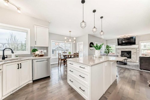 2201 Bayside Circle Sw, Airdrie, AB - Indoor Photo Showing Kitchen With Fireplace