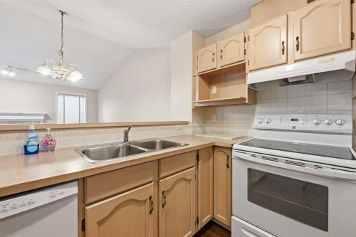 25 Tararidge Circle Ne, Calgary, AB - Indoor Photo Showing Kitchen With Double Sink