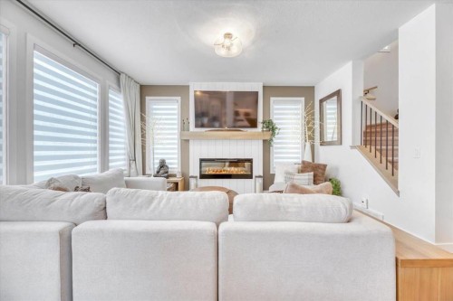 77 Versant Point Sw, Calgary, AB - Indoor Photo Showing Living Room With Fireplace