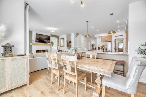 77 Versant Point Sw, Calgary, AB - Indoor Photo Showing Dining Room With Fireplace