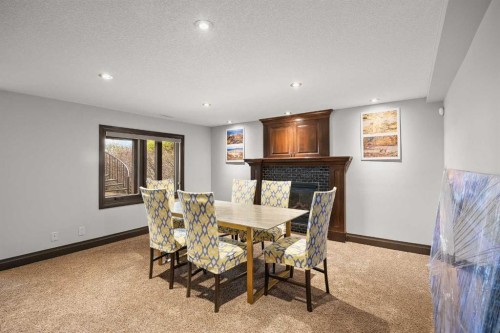136 Edelweiss Drive Nw, Calgary, AB - Indoor Photo Showing Dining Room With Fireplace