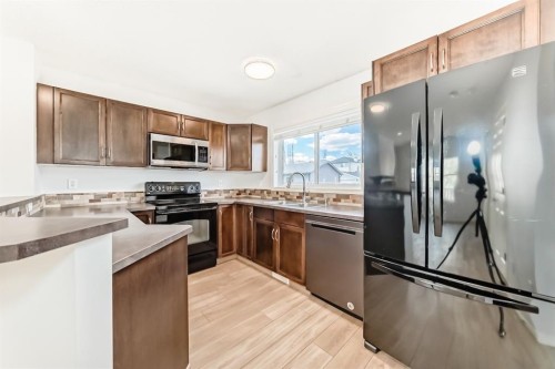 137 Eversyde Boulevard Sw, Calgary, AB - Indoor Photo Showing Kitchen With Double Sink