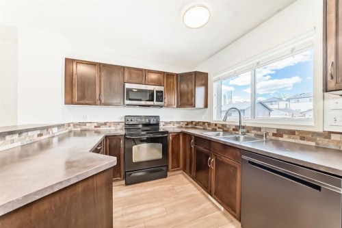 137 Eversyde Boulevard Sw, Calgary, AB - Indoor Photo Showing Kitchen With Double Sink