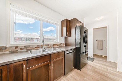 137 Eversyde Boulevard Sw, Calgary, AB - Indoor Photo Showing Kitchen With Double Sink
