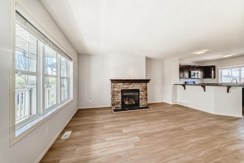 137 Eversyde Boulevard Sw, Calgary, AB - Indoor Photo Showing Living Room With Fireplace
