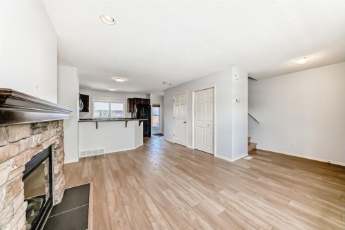 137 Eversyde Boulevard Sw, Calgary, AB - Indoor Photo Showing Other Room With Fireplace