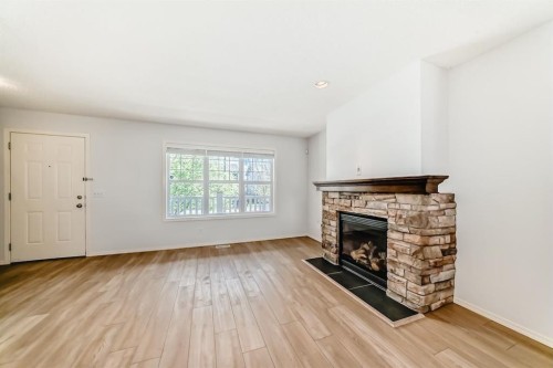 137 Eversyde Boulevard Sw, Calgary, AB - Indoor Photo Showing Living Room With Fireplace