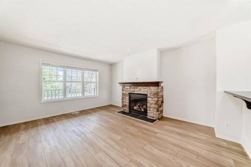 137 Eversyde Boulevard Sw, Calgary, AB - Indoor Photo Showing Living Room With Fireplace