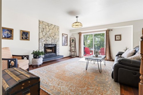 235 Deerview Drive Se, Calgary, AB - Indoor Photo Showing Living Room With Fireplace