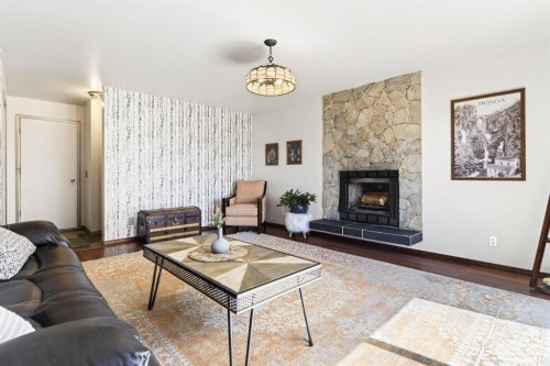 235 Deerview Drive Se, Calgary, AB - Indoor Photo Showing Living Room With Fireplace