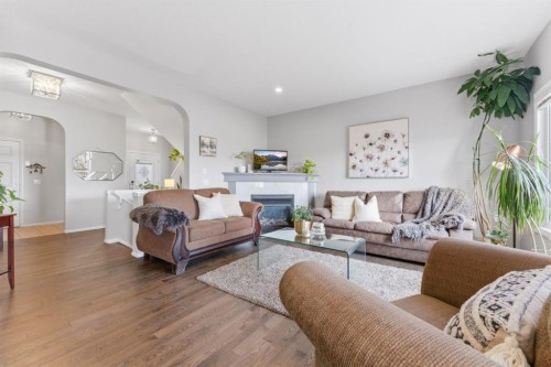 138 Bridlerange Place Sw, Calgary, AB - Indoor Photo Showing Living Room With Fireplace