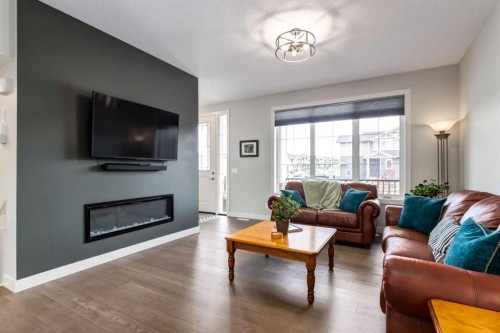 52 Mill Road, Cochrane, AB - Indoor Photo Showing Living Room With Fireplace