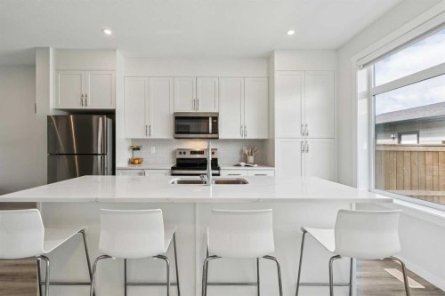 201 Vantage Drive, Cochrane, AB - Indoor Photo Showing Kitchen With Stainless Steel Kitchen With Upgraded Kitchen
