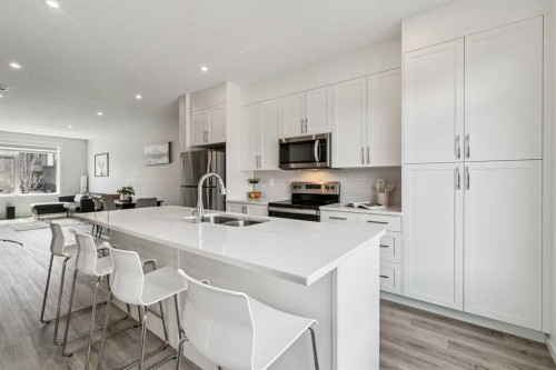 201 Vantage Drive, Cochrane, AB - Indoor Photo Showing Kitchen With Stainless Steel Kitchen With Double Sink With Upgraded Kitchen