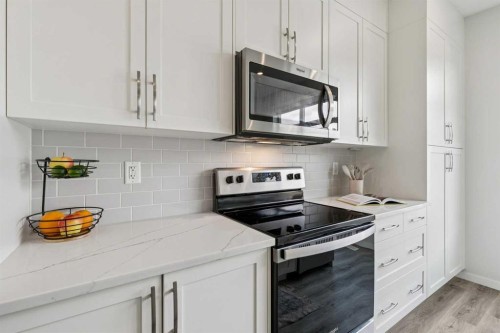 201 Vantage Drive, Cochrane, AB - Indoor Photo Showing Kitchen With Upgraded Kitchen