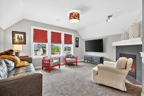31 Kingston View Se, Airdrie, AB - Indoor Photo Showing Living Room With Fireplace