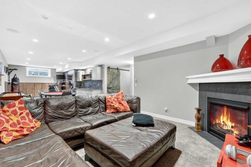 31 Kingston View Se, Airdrie, AB - Indoor Photo Showing Living Room With Fireplace