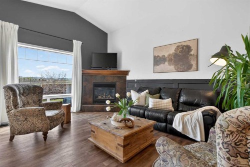 283 Willow Ridge Manor, Diamond Valley, AB - Indoor Photo Showing Living Room With Fireplace