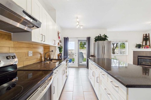 144 Simcoe Place Sw, Calgary, AB - Indoor Photo Showing Kitchen With Double Sink