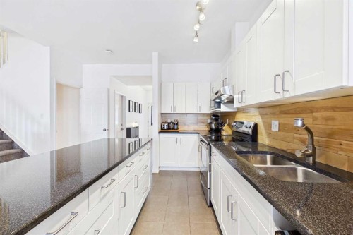 144 Simcoe Place Sw, Calgary, AB - Indoor Photo Showing Kitchen With Double Sink