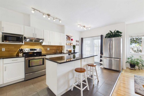 144 Simcoe Place Sw, Calgary, AB - Indoor Photo Showing Kitchen With Stainless Steel Kitchen