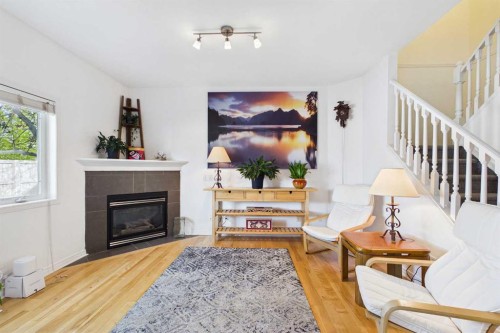 144 Simcoe Place Sw, Calgary, AB - Indoor Photo Showing Living Room With Fireplace
