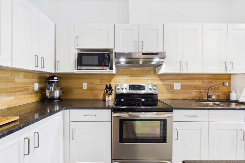 144 Simcoe Place Sw, Calgary, AB - Indoor Photo Showing Kitchen With Double Sink