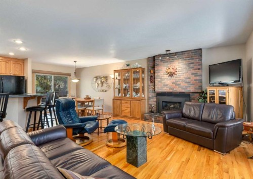 4808 Valiant Drive Nw, Calgary, AB - Indoor Photo Showing Living Room With Fireplace